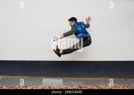 A young male asian dancer moves in a London street Stock Photo