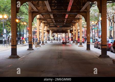 A view under the iconic L train tracks in chicago crossing LaSalle Stock Photo