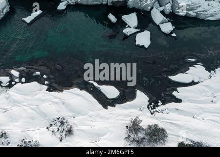 Blue water and ice in winter. Aerial drone top down view. Norway Stock Photo