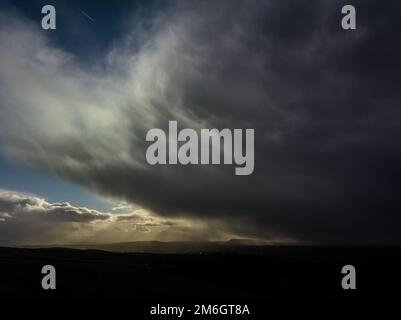 Rain Clouds shadow Pendle Hill in the distance Stock Photo