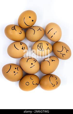 Many eggs with different reactions seen from above on white background Stock Photo