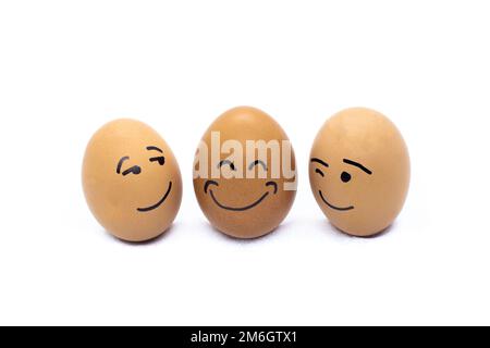 Two eggs flirting and one very happy on white background Stock Photo