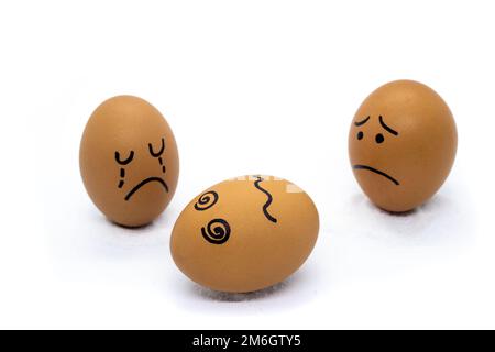 One egg crying, one egg worried, and one dead Stock Photo