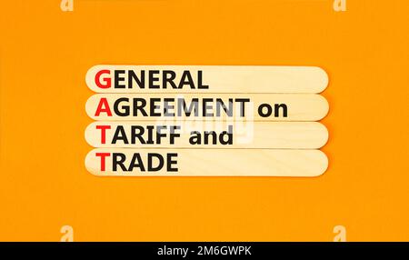 GATT symbol. Concept words GATT general agreement on tariff and trade on wooden stick on beautiful orange background. Business GATT general agreement Stock Photo