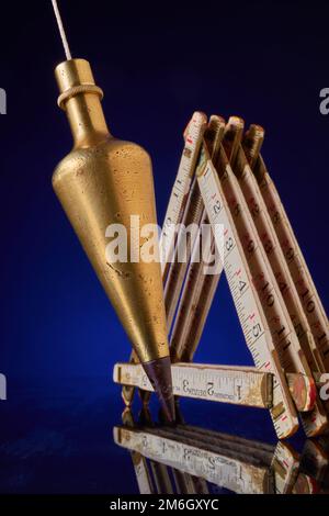 Plumb bob & carpenter's scale, antique surveying equipment Stock Photo