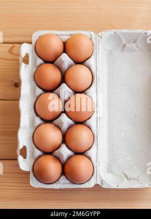 A few brown eggs among the empty cells of a large cardboard bag Stock Photo