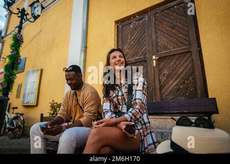 A multiracial friends are having fun conversation while taking a rest Stock Photo