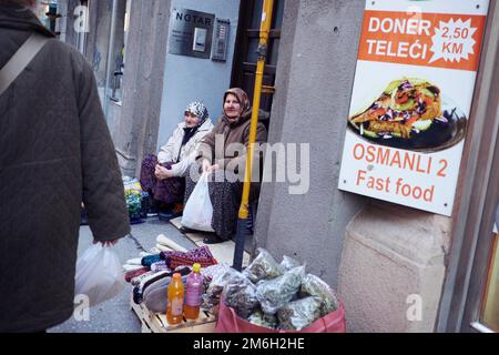 women sell vegetables and clothing on the street in Sarajevo Stock Photo