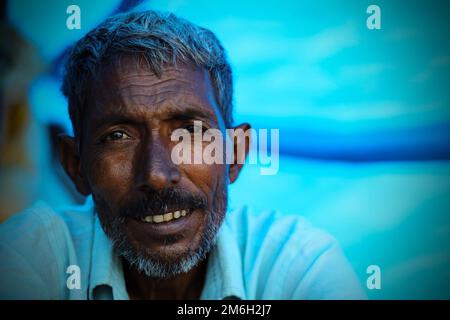 Vadodara, Gujarat - November 19th 2022: Aged Indian man close up face with wrinkled skin and grey hair good and beautiful face smoking Stock Photo