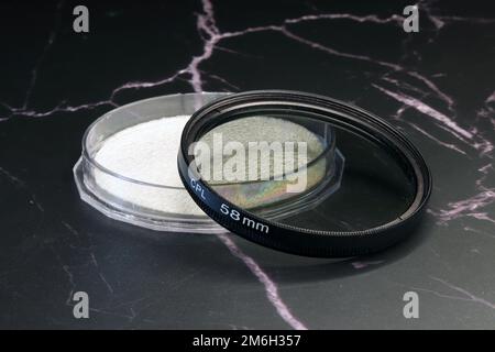 circular polarizing filter on a dark background Stock Photo
