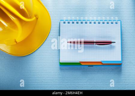 Checked notebook pen building helmet. Stock Photo
