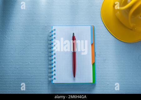 Checked notepad pen building helmet. Stock Photo