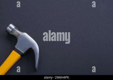 claw hammer with yellow handle on black background Stock Photo