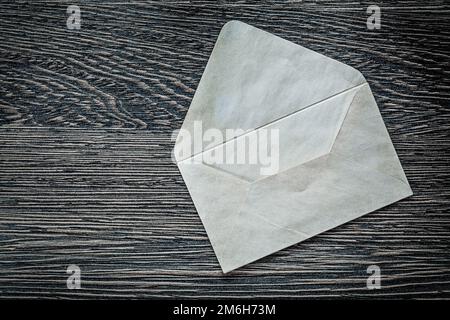 Opened vintage envelope on black board. Stock Photo