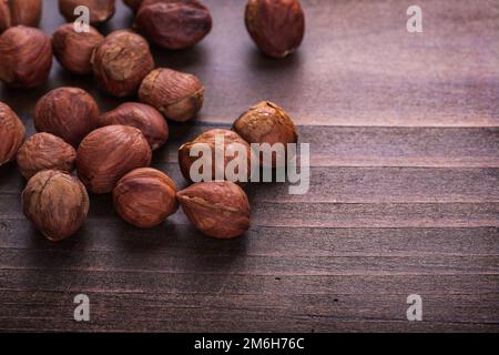 organized copyspace hazelnuts on vintage wooden board Stock Photo