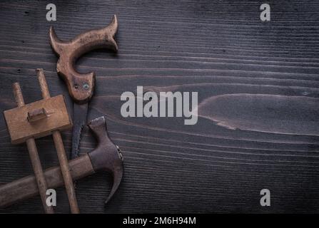 Rusted hand saw wooden marking gauge claw hammer copy space. Stock Photo