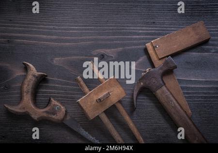 Rusted hand saw wooden marking gauge claw hammer square ruler. Stock Photo