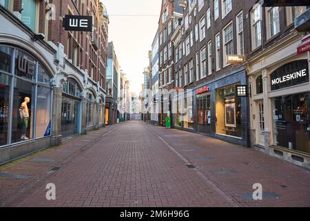 A view of a deserted Kalverstraat during Covid-19 lockdown, in the coronavirus pandemic in Amsterdam Stock Photo