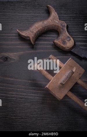 Vintage hand saw marking gauge on wooden board construction concept. Stock Photo