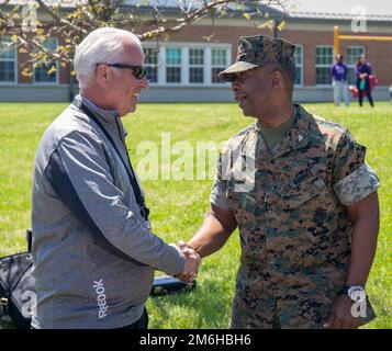 Miles Shea, principal, Quantico Middle High School shakes hands with U.S. Marine Corps Col. Michael L. Brooks, commanding officer, Marine Corps Base Quantico,  during the signing of the Adopt a School proclamation at Quantico Middle High School on Marine Corps Base Quantico, Virginia, April 28, 2022. The signing of the proclamation showcases the mutually agreed upon partnership between the MCBQ's DoDEA schools and military commands. . Stock Photo