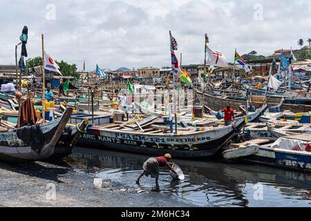 Colourful flags, traditional fishing boats, Elmina fishing port, Gold Coast, Gulf of Guinea, Ghana Stock Photo