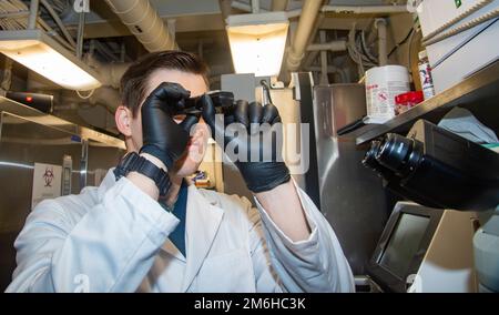 220428-N-TO573-1033 ADRIATIC SEA (April 28, 2022) Hospital Corspman 2nd Class J.D. Byrum, from Maiden, North Carolina, runs quality control on a hematology analyzer aboard the Nimitz-class aircraft carrier USS Harry S. Truman (CVN 75), April 28, 2022. The Harry S. Truman Carrier Strike Group is on a scheduled deployment in the U.S. Sixth Fleet area of operations in support of U.S., allied and partner interests in Europe and Africa. Aircraft Carrier,Forged by the Sea,Sailor,USN,USS Harry S. Truman (CVN 75), Stock Photo