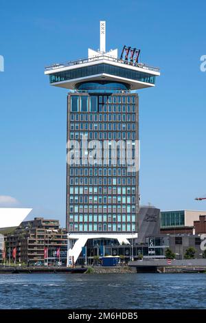 High-rise building with a swing on the roof by the city canals, Amsterdam, Netherlands Stock Photo