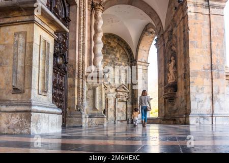 Mother and son in the arches of the entrance of the Sanctuary of Loyola, Baroque church of Azpeitia Stock Photo
