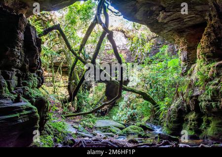 River running through stone cave in Carrancas Stock Photo