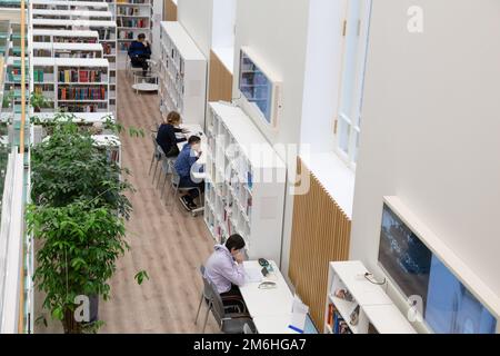 St. Petersburg, Russia - November 15, 2022: V. V. Mayakovsky Central City Public Library. Youth, students are engaged in the reading room of the libra Stock Photo