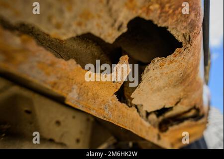 Fragment of a car body with rust. fragment of a rusty wing of a car. The body element is corroded. Concept: corrosion resistance Stock Photo