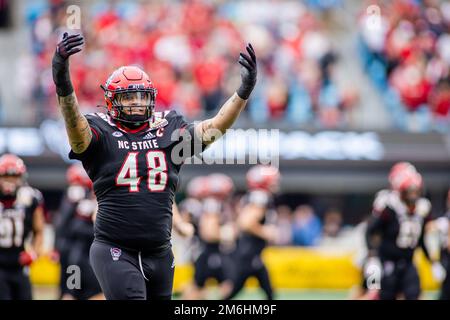 Charlotte, NC, USA. 30th Dec, 2022. North Carolina State Wolfpack defensive tackle Cory Durden (48) pumps up the fans before the 2022 Duke's Mayo Bowl at Bank of America Stadium in Charlotte, NC. (Scott Kinser/CSM). Credit: csm/Alamy Live News Stock Photo