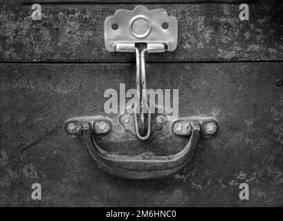A metal chest with its latch for a padlock, handle on a chest, suitcase. Stock Photo