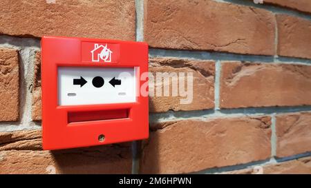 Fire alarm system box installed on wall in building. Stock Photo