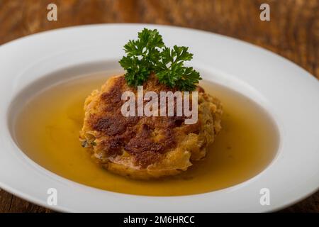 Austrian cheese dumplings in broth Stock Photo