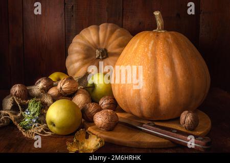 Pumpkin and fruits on dark wooden background Stock Photo