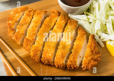 Homemade Japanese Chicken Tonkatsu with Cabbage and Lemon Stock Photo