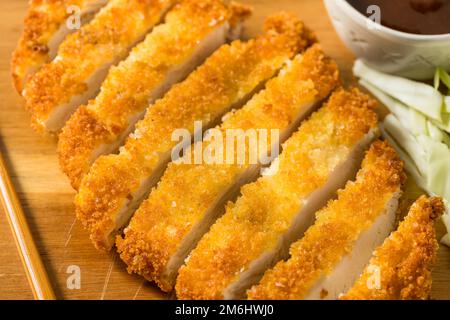 Homemade Japanese Chicken Tonkatsu with Cabbage and Lemon Stock Photo