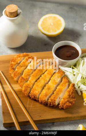 Homemade Japanese Chicken Tonkatsu with Cabbage and Lemon Stock Photo