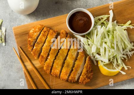 Homemade Japanese Chicken Tonkatsu with Cabbage and Lemon Stock Photo