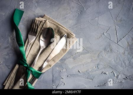 Cutlery set with green ribbon Stock Photo