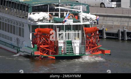 MOSCOW , RUSSIA, June 10, 2021: Red Riverboat Paddle Wheel in a River with Treeson June 10, 2021 in Moscow, Russia Stock Photo