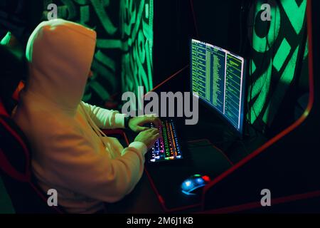 Hacker using computer malware software and hacking binary code digital interface. Stock Photo