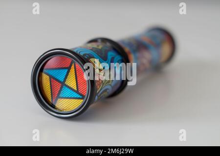 Close-up of a kid's kaleidoscope toy used to create abstract images while looking through the viewfinder. Selective focus. Stock Photo