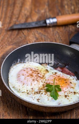 Eggs sunny side up in a pan Stock Photo