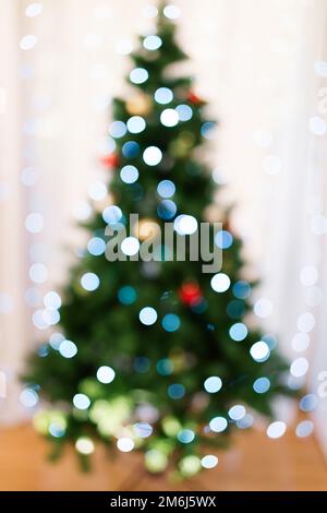 Defocused christmas tree silhouette with blurred lights Stock Photo