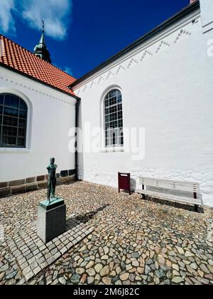 Lemvig Church with sculpture Standing Man in bronze, Denmark Stock Photo