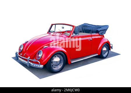 An absolutely pristine mid-1960s VW Volkswagen Beetle convertible with the top down on white. Stock Photo