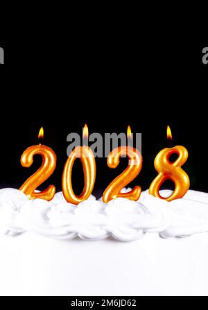 Golden candles write numbers flame Happy new year 2028 Stock Photo