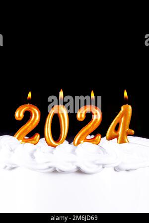 Golden candles write numbers flame Happy new year 2024 Stock Photo